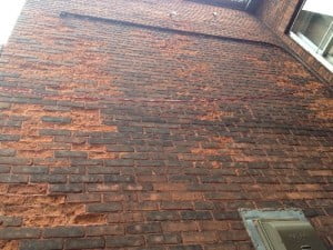 Wall with bricks spalling